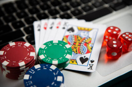 Poker chips and cards on computer keyboard