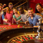 Group Of Friends Playing Roulette In Casino