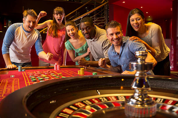 Group Of Friends Playing Roulette In Casino